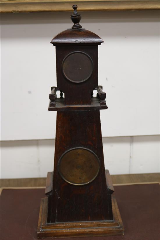 A late Victorian carved oak Lighthouse  clock barometer by Frank Flower of St James